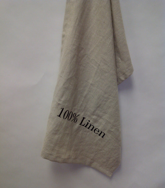 Linen tea towel embroidered with "100% Linen" in black thread.  Natural linen.